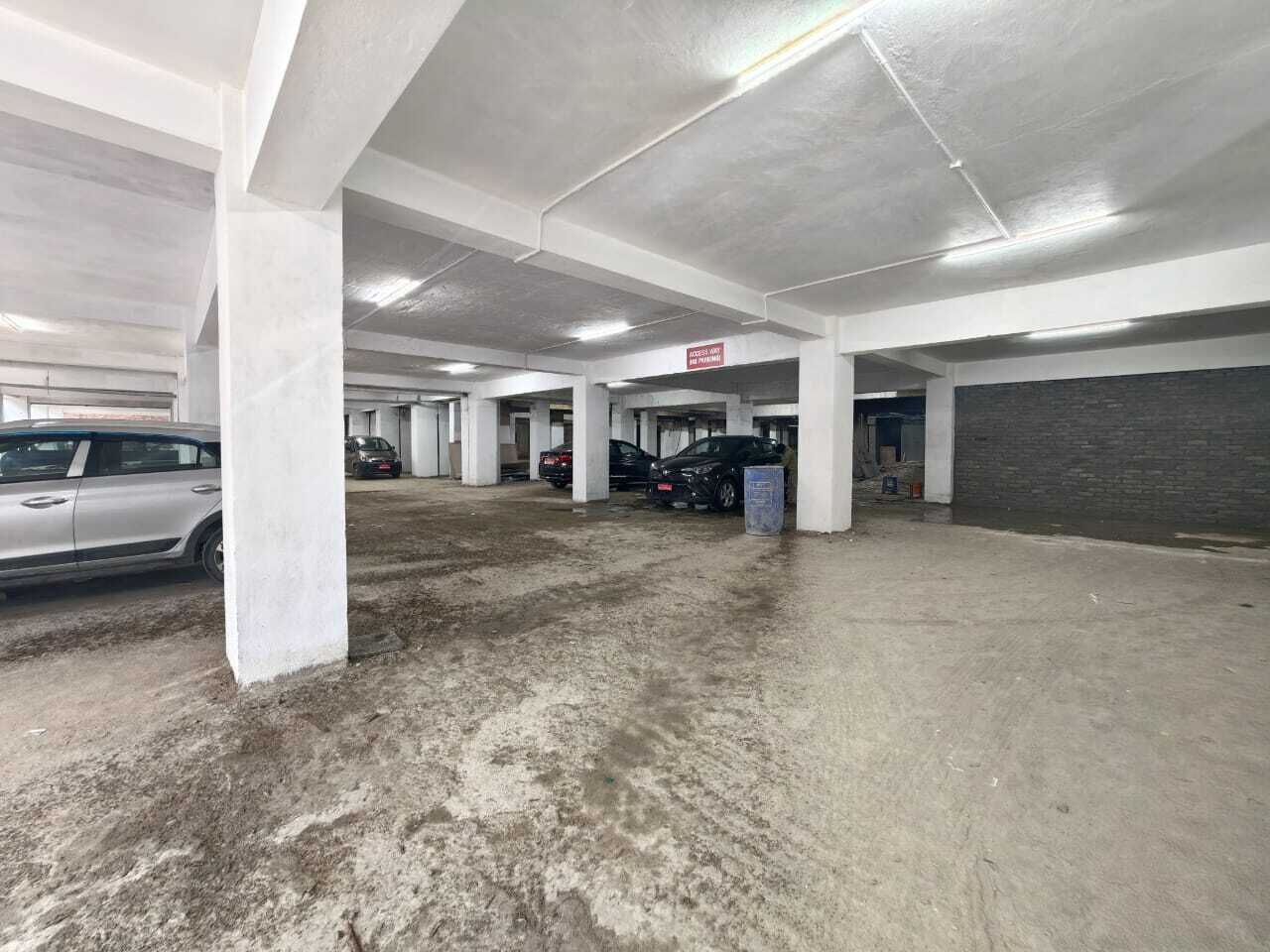 A multi-level parking garage with concrete pillars and a clean, well-lit environment.
