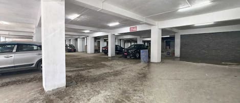 A multi-level parking garage with concrete pillars and a clean, well-lit environment.