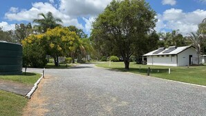 A gravel driveway leading to a building with a sign indicating a no parking zone. - 1 Showgrounds Road Horse Creek QLD 4714 (Horse Creek)