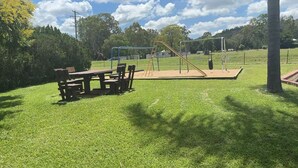 A park with a picnic table, playground equipment, and a grassy area. - 1 Showgrounds Road Horse Creek QLD 4714 (Horse Creek)