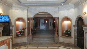 A grand hallway with marble floors, a central staircase, and two columns on either side. - Premium Swiss Residence Mohandessin (Cairo)
