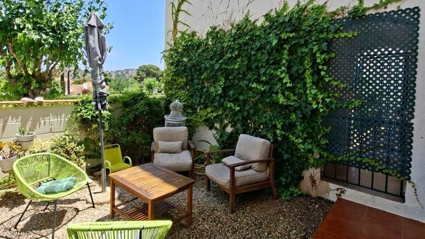 A patio with outdoor furniture, a pergola, and a wall covered in climbing plants. - Fantastic apartment in La Manga Club. Swimming pool, restaurants, pubs, golf beach (Cartagena)