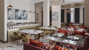 A spacious dining area with multiple tables, chairs, and a bar counter. - Surxondaryo Hotel (Tashkent)