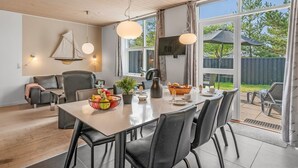 A modern dining area with a wooden ceiling, large windows, and a view of the outdoors. - "Lucjan" - 800m from the sea by Interhome (Vejers Strand)