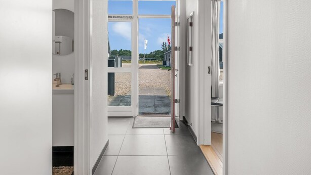 A hallway with a glass door leading outside, a tiled floor, and a wooden ceiling. - "Lucjan" - 800m from the sea by Interhome (Vejers Strand)