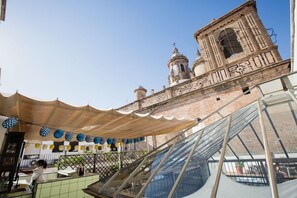 A restaurant with a view of a historic building with domes and a bell tower. - Joy Setas Coworking (Seville)