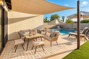 A patio with a pool, outdoor furniture, and a covered seating area. - Casa Del Rey Old Town Retreat | Pool & Casita (Scottsdale)