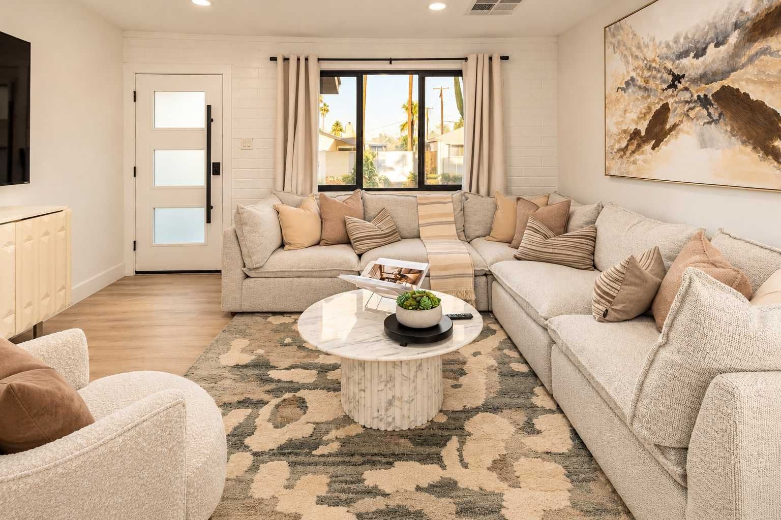 A living room with two sofas, a coffee table, and a view of the outdoors through a sliding door.