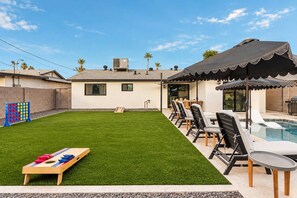 A backyard with a pool, outdoor seating, and a game table. - Casa Del Rey Old Town Retreat | Pool & Casita (Scottsdale)