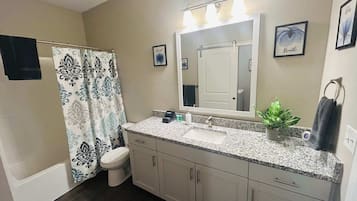 Shower, hair dryer, towels, shampoo