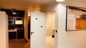 A modern kitchen with built-in appliances and a dining area. - Cowool Compiègne (Compiègne)
