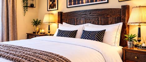 A well-appointed hotel room with a large bed, a wooden headboard, and a cityscape view.