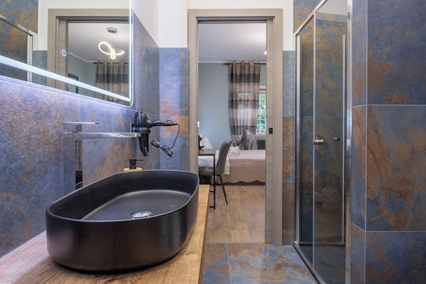 Superior Room | Bathroom | Hair dryer, towels, soap, shampoo