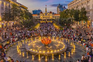 A public square with a central fountain, surrounded by buildings and trees. - G8 Riverside Hotel & Rooftop Skybar (Ho Chi Minh City)