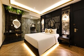 A modern bedroom with a large bed, a vanity with a mirror, and a wall-mounted toilet. - G8 Riverside Hotel & Rooftop Skybar (Ho Chi Minh City)