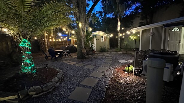 A patio area with stone tiles, outdoor furniture, and string lights. - Short driving distance from St. George's shopping and the serene Vilano Beach (St Augustine)