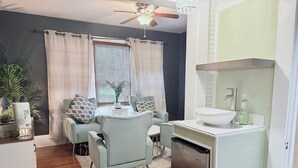 A modern living room with a dining area, a built-in sink, and a ceiling fan. - Short driving distance from St. George's shopping and the serene Vilano Beach (St Augustine)