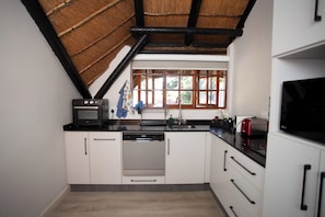 Luxury Studio Suite, Balcony, Pool View | Private kitchen | Full-sized fridge, microwave, oven, stovetop