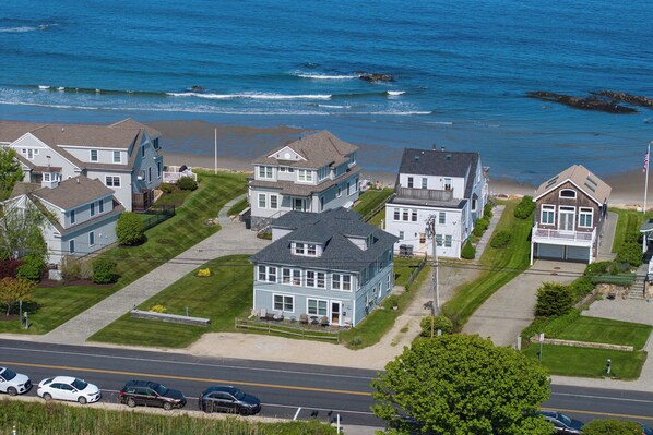 A coastal residential area with houses, a road, and a beach. - Ocean-View Rye Beach Condo | Private Beach Access & Walk to Petey’s Seafood (Rye)