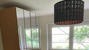 A bedroom with a bed, a wardrobe, a window, and a radiator. - Entire Apartment in a Quiet Location (Oerlenbach)