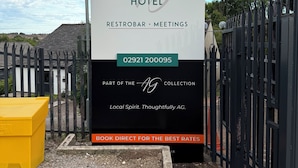 A sign for The Beacon Hotel advertising restrooms and meetings, part of the AG collection, with a booking rate prompt. - The Beacon Hotel, Cardiff, Part of the AG Collection (Cardiff)