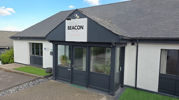 A hotel named "The Beacon Hotel" with a modern design, featuring a dark facade, large windows, and a visible entrance. - The Beacon Hotel, Cardiff, Part of the AG Collection (Cardiff)