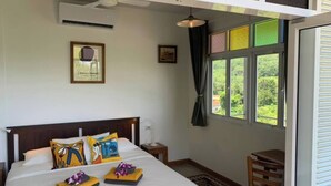 A hotel room with a large bed, a small table, a chair, a window with curtains, and a ceiling fan. - Boho-Luxe Pool Villa with Simply Amazing Views by Setting Sun Boutique Homes (ตำบล เกาะลันตาใหญ่)