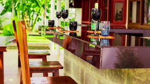 Una zona de bar con sillas de madera y una barra larga.