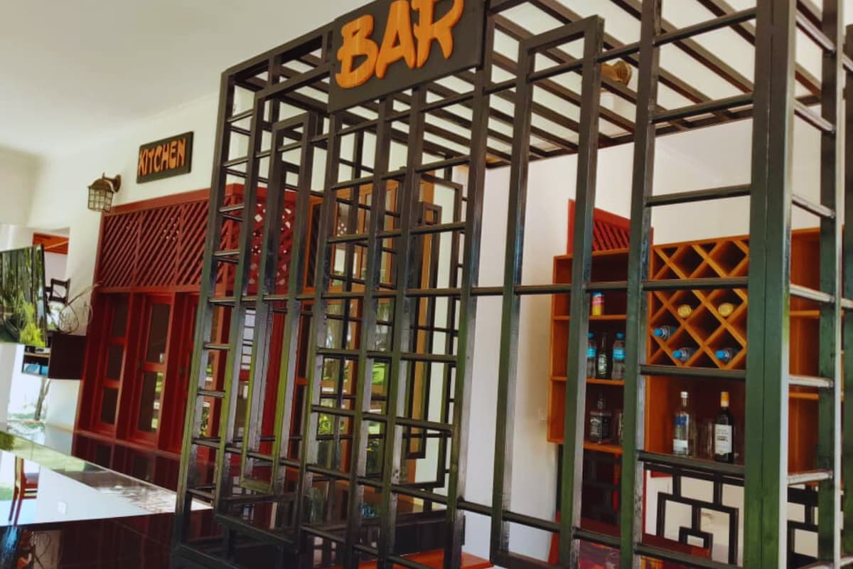 A bar area with a sign labeled "BAR" and a "KITCHEN" sign above it.
