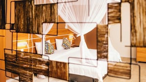 A modern hotel room with a bed, white bedding, and a canopy bed. - Migano Residence (Bujumbura)