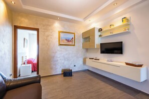 Apartment (1 Bedroom) | Living area | 32-inch Smart TV with cable channels - Amedeo di Savoia Sea & Sunsets (Naples)