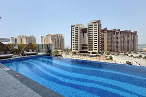 Outdoor pool, open 9:00 AM to 7:00 PM, pool umbrellas, pool loungers
