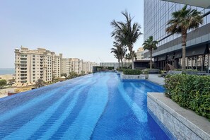 Outdoor pool, open 9:00 AM to 7:00 PM, pool umbrellas, pool loungers