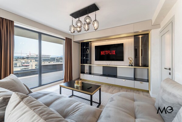 Deluxe Apartment, Mountain View | Living area | 150-cm flat-screen TV with cable channels, Netflix, streaming services - MoHost Valcom - Luxury Skyline Penthouse (Brașov)