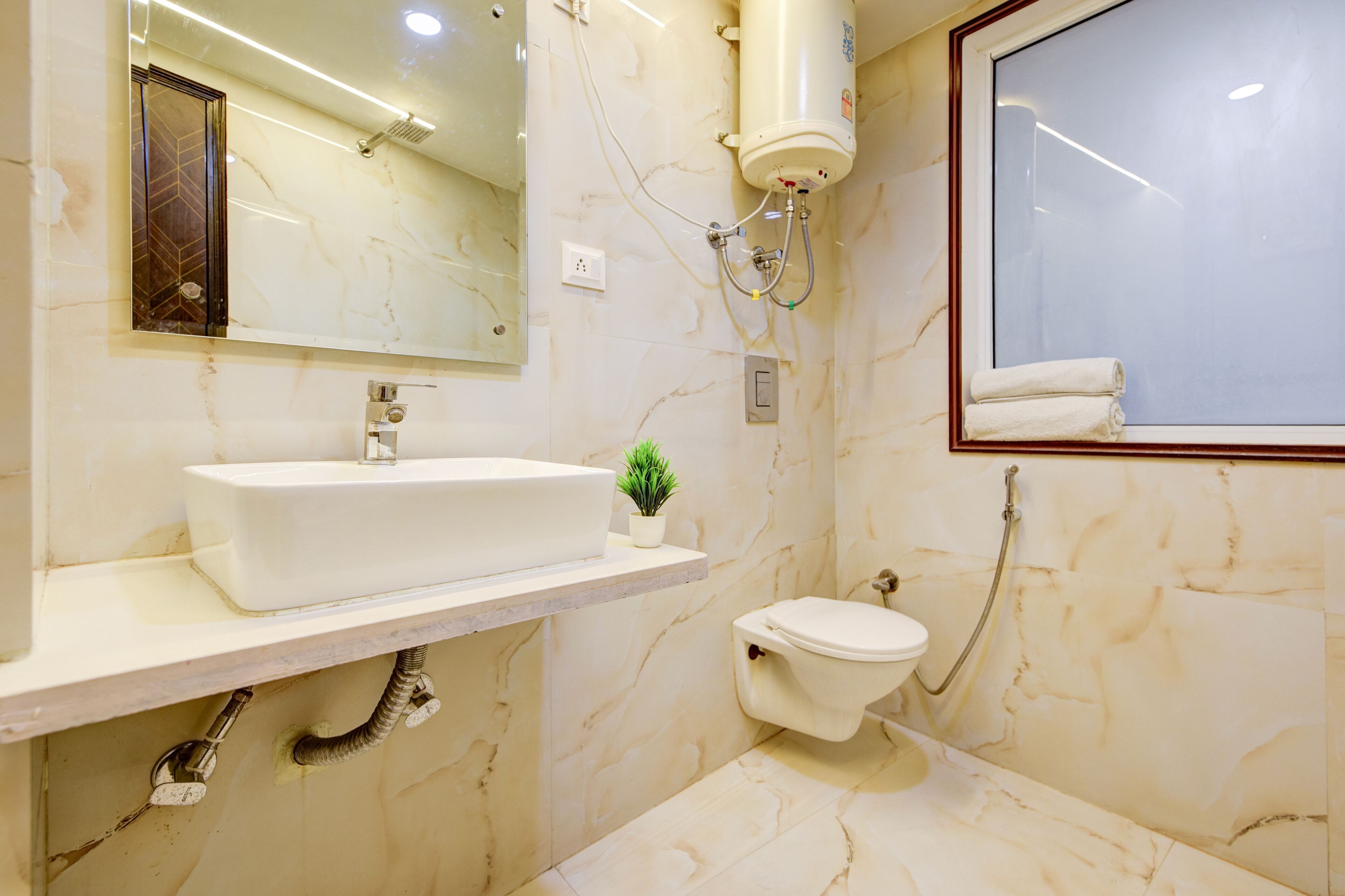 A bathroom with a white sink, a toilet, and a shower.