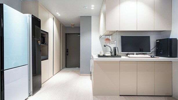 A modern kitchen with a refrigerator, microwave, and a built-in oven. - JIncheon hotel hue (Jincheon)