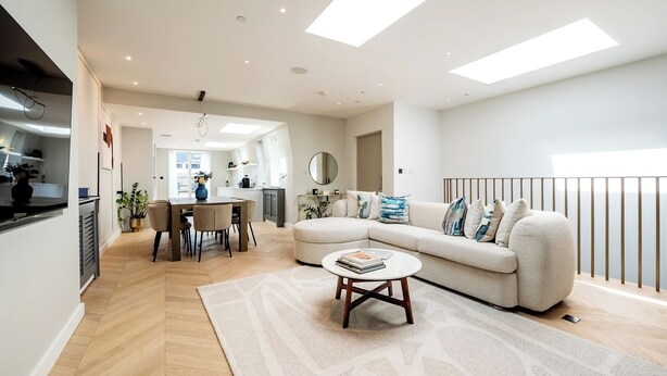 A modern living room with a sofa, coffee table, and dining area. - Soak in the Spalike Marble Bath at Plush Penthouse (Greater London)