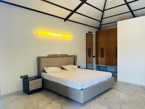 Un dormitorio moderno con cama, mesitas de noche y un armario empotrado.