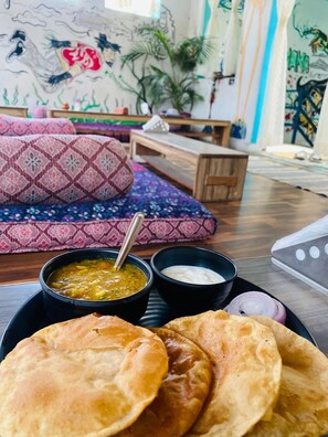 A dining setup with flatbreads, a bowl of soup, and a bowl of yogurt. - The Pink Chapter Hostel, Jaipur (Jaipur)