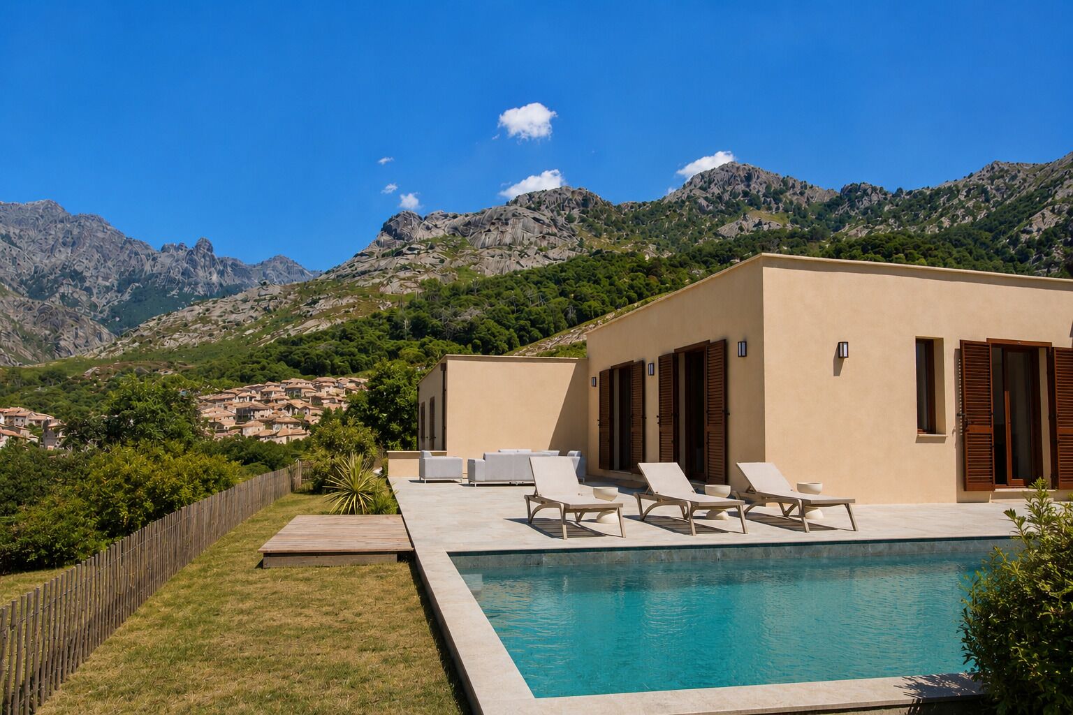 A modern villa with a swimming pool, lounge chairs, and a view of mountains.