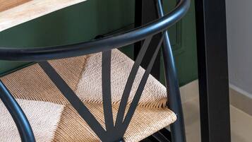 A wooden table with a black metal chair.