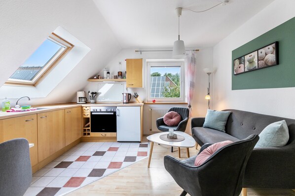 A compact apartment with a kitchenette, a dining area, and a living room with a sofa and armchairs. - Apartment 'Dohle No 1' with Shared Terrace, Shared Garden and Wi-Fi (Vollerwiek)