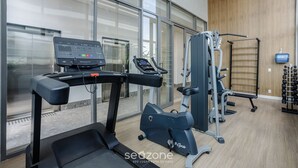 A gym with treadmills, an elliptical, and weight machines. - Modern and Fully Equipped Apartments, With Leisure Facilities and in the Best Location in Pinheiros - SP - EGP (São Paulo)