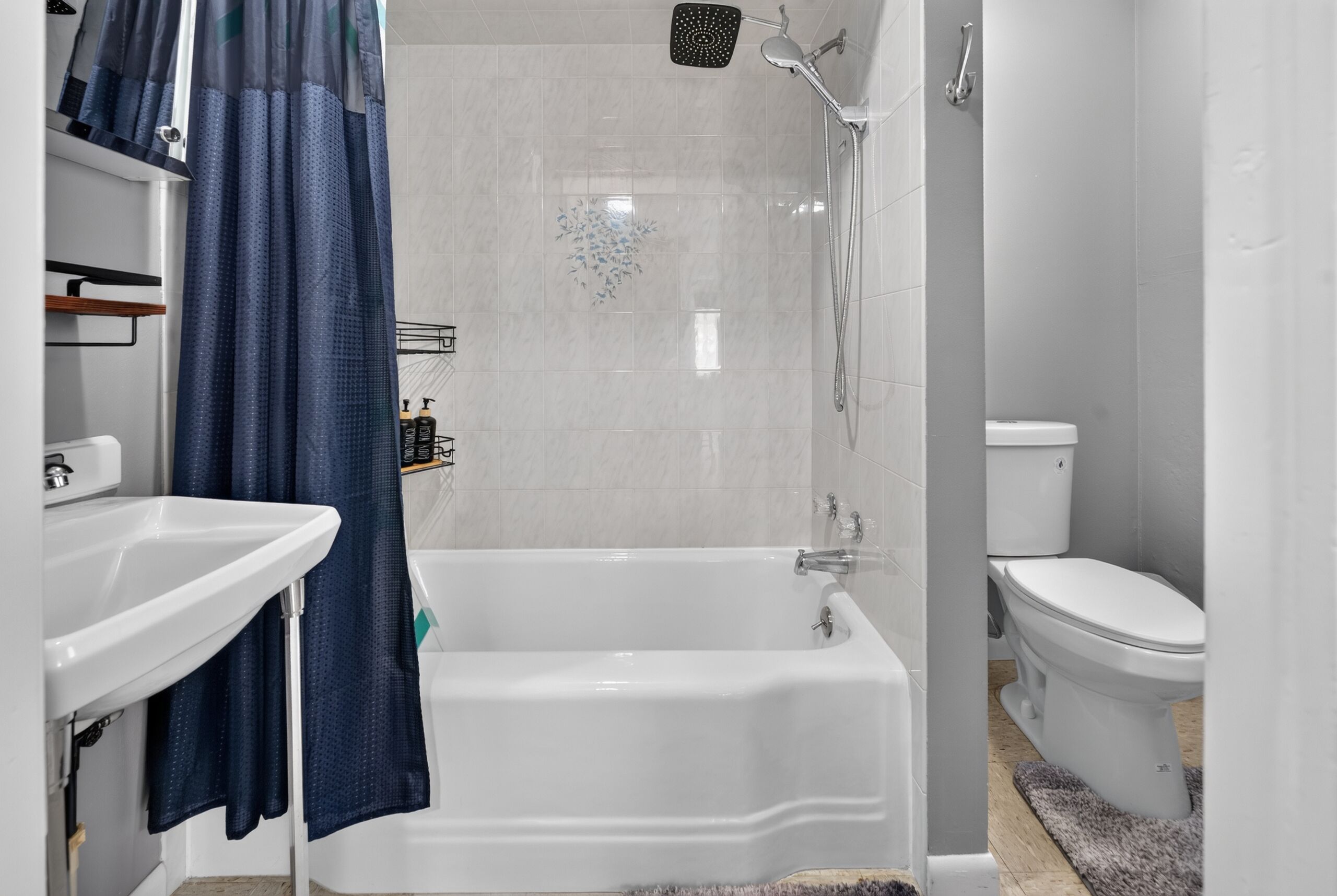 A bathroom with a bathtub, toilet, and shower.