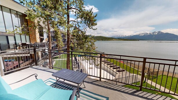 A balcony with a pool table, outdoor seating, and a view of a lake and mountains. - On Lake, WOW Views, Big Deck! Walk to Amp, Events, Parks, Marina, Tiki Bar (Dillon)