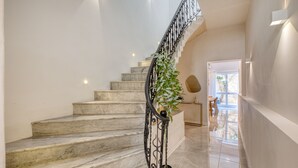 A marble staircase with a wrought iron railing, a potted plant, and a view of the outside. - Impressive 3 bedrooms, sun terrace, jacuzzi AMRA1-1 (Sliema)