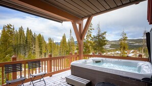 A hot tub on a wooden deck with a view of a forest and mountains. - Cloudline Chalet 3 Bedroom Townhouse (Winter Park)