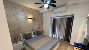 A modern bedroom with a bed, nightstands, a ceiling fan, and a window with curtains.