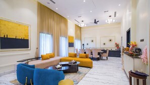 Una sala de estar moderna con un sofá seccional, una mesa de centro y un comedor con sillas y una mesa.