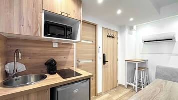 Fridge, microwave, coffee/tea maker, cookware/dishes/utensils